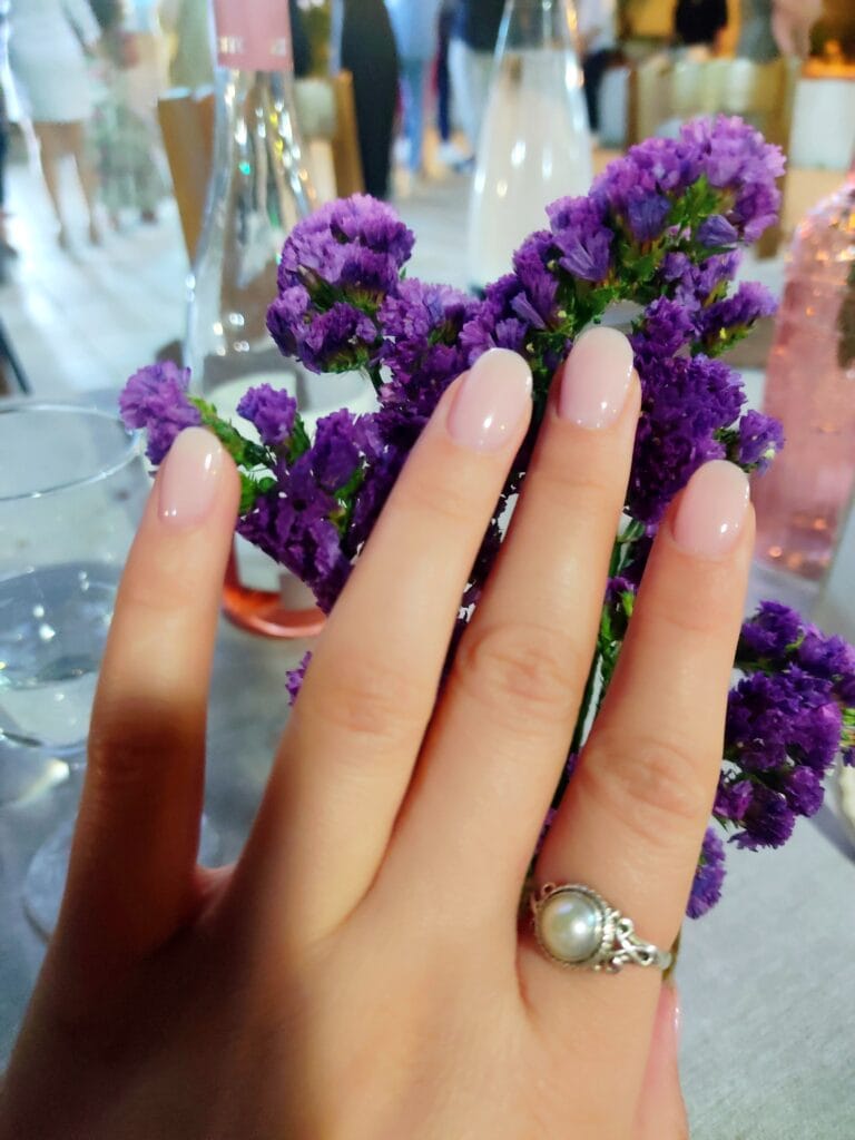 female hand with round baby pink nails, nail ideas